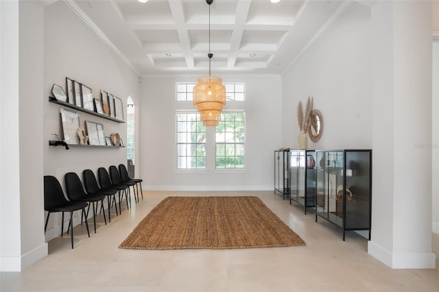 interior space with beamed ceiling, coffered ceiling, baseboards, and a towering ceiling