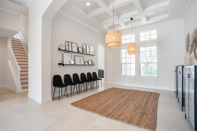 interior space featuring coffered ceiling, beam ceiling, arched walkways, stairs, and a towering ceiling