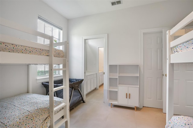 bedroom featuring light tile patterned flooring, visible vents, and multiple windows