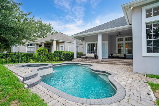 view of pool featuring a patio, fence, an outdoor living space, a pool with connected hot tub, and ceiling fan