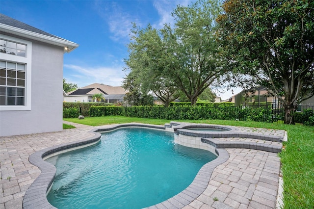 view of pool with a patio area, a lawn, a pool with connected hot tub, and fence