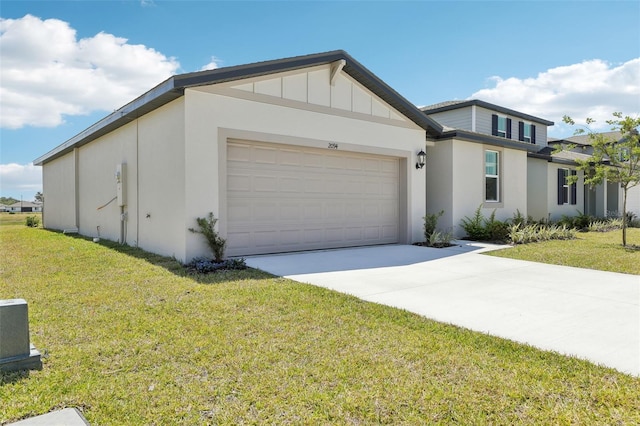 view of front facade with an attached garage, driveway, a front yard, and stucco siding