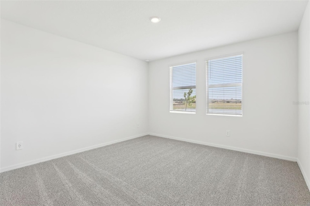 carpeted spare room with baseboards and recessed lighting