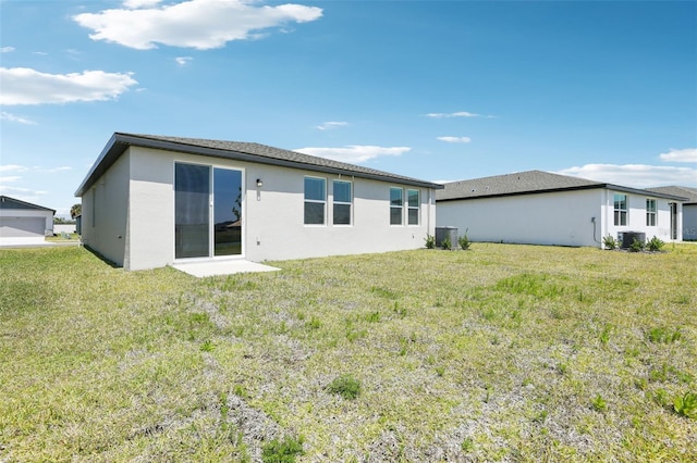 back of property featuring a lawn and cooling unit