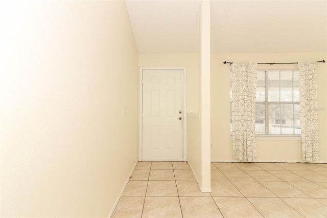 empty room featuring light tile patterned floors and baseboards