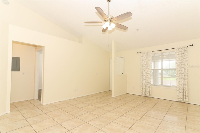 empty room with light tile patterned floors, ceiling fan, electric panel, and high vaulted ceiling