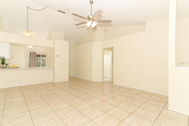 unfurnished room featuring visible vents, vaulted ceiling, a ceiling fan, and light tile patterned flooring