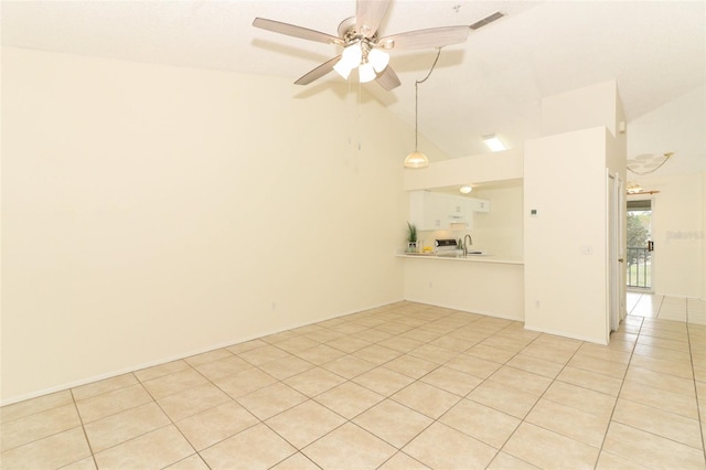 spare room featuring light tile patterned floors, visible vents, ceiling fan, vaulted ceiling, and a sink