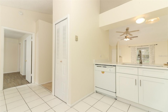 kitchen with dishwasher, light countertops, light tile patterned floors, and a sink