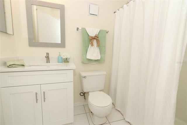 bathroom featuring tile patterned flooring, baseboards, vanity, and toilet