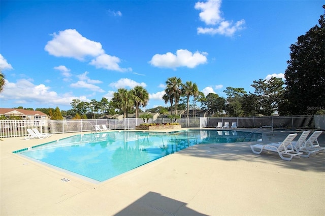 community pool featuring a patio and fence