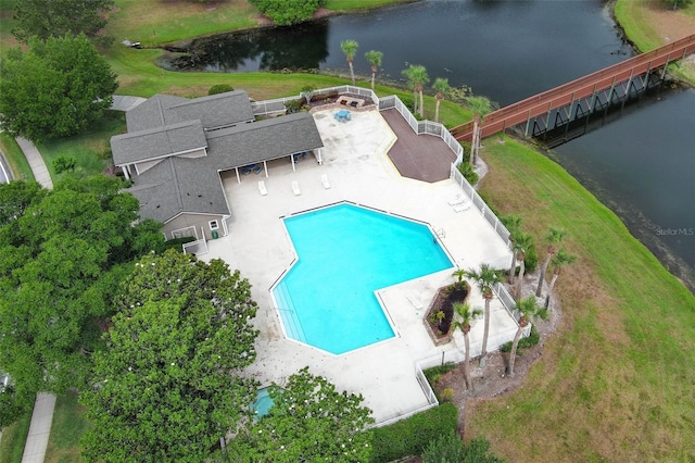 community pool with a patio area and a water view