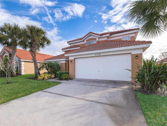 mediterranean / spanish-style house with stucco siding, a front lawn, concrete driveway, a garage, and a tiled roof