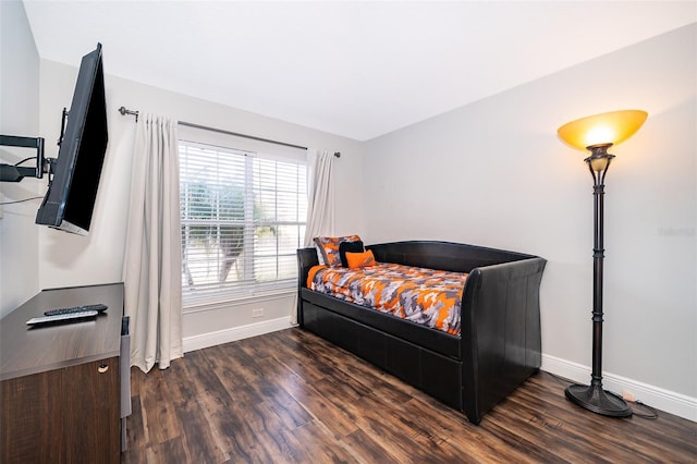 bedroom with baseboards and wood finished floors