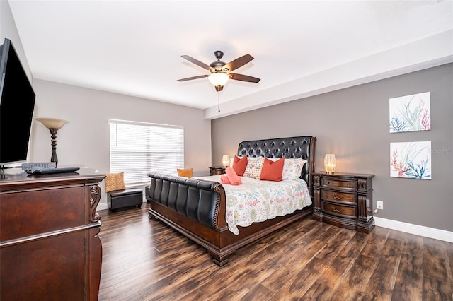 bedroom with a ceiling fan, dark wood-style floors, and baseboards