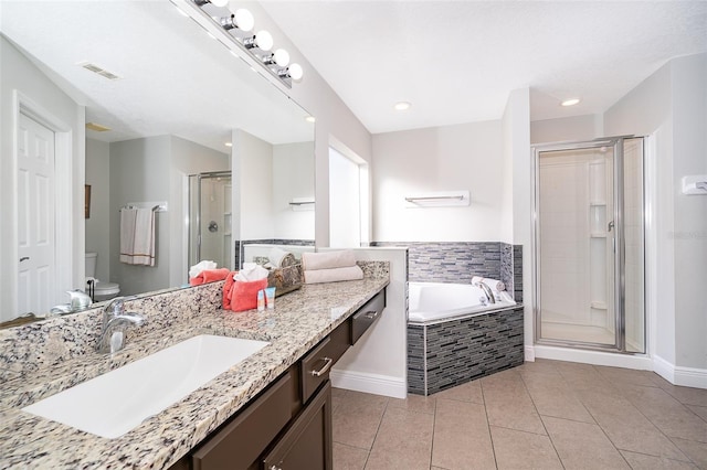 bathroom with visible vents, a shower stall, a garden tub, toilet, and tile patterned floors