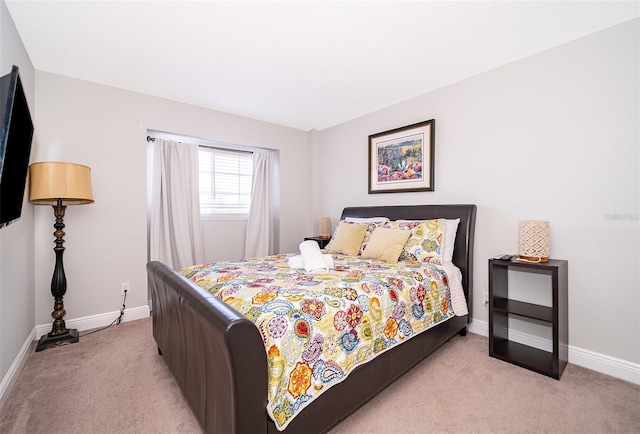 bedroom featuring baseboards and light colored carpet