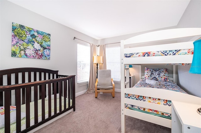 carpeted bedroom featuring baseboards