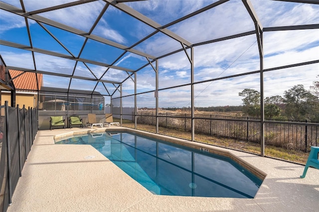 view of pool with a patio, fence, and a lanai