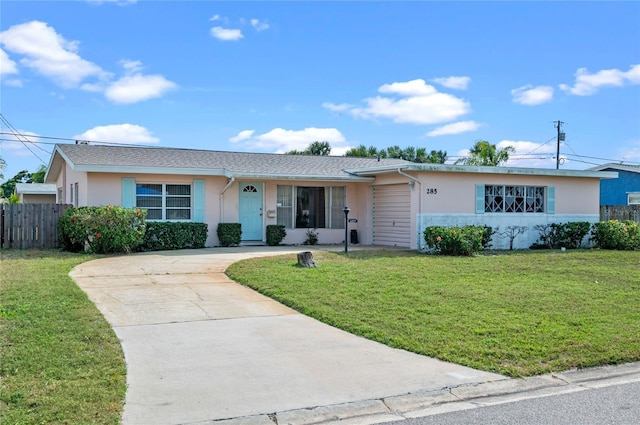 ranch-style home featuring a front lawn, fence, and stucco siding