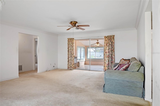 living area featuring visible vents, a ceiling fan, ornamental molding, and carpet flooring