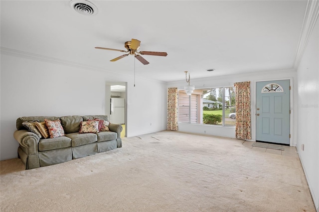 living room featuring a ceiling fan, crown molding, carpet, and visible vents