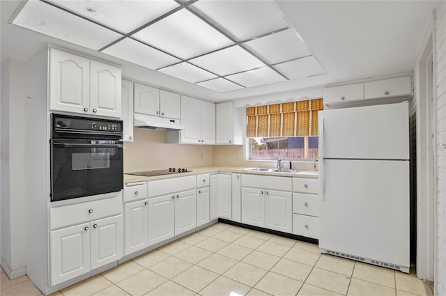 kitchen featuring black appliances, under cabinet range hood, light countertops, white cabinetry, and a sink