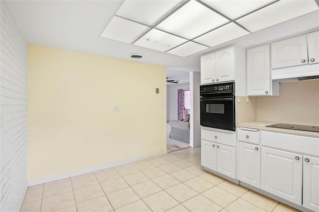 kitchen with light tile patterned floors, visible vents, black appliances, white cabinets, and under cabinet range hood