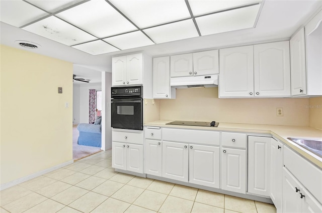 kitchen featuring under cabinet range hood, white cabinetry, black appliances, and light countertops