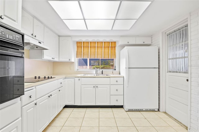 kitchen with black appliances, a sink, under cabinet range hood, white cabinets, and light tile patterned floors