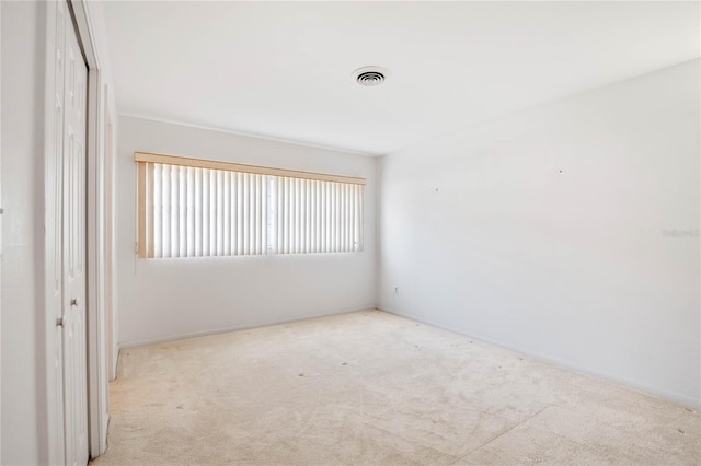 carpeted spare room with visible vents