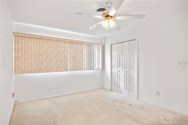 unfurnished bedroom featuring a ceiling fan, carpet, and a closet