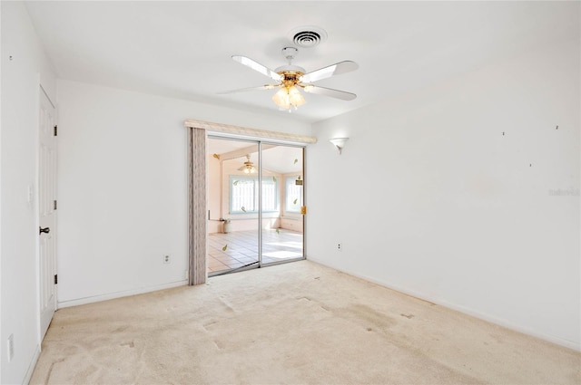 unfurnished bedroom featuring carpet flooring, visible vents, and ceiling fan