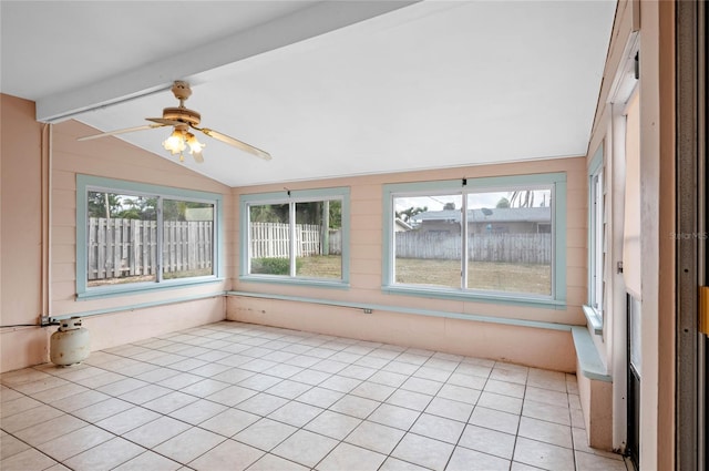 unfurnished sunroom featuring lofted ceiling with beams and a ceiling fan