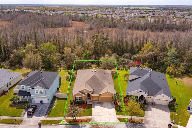 bird's eye view featuring a residential view and a wooded view