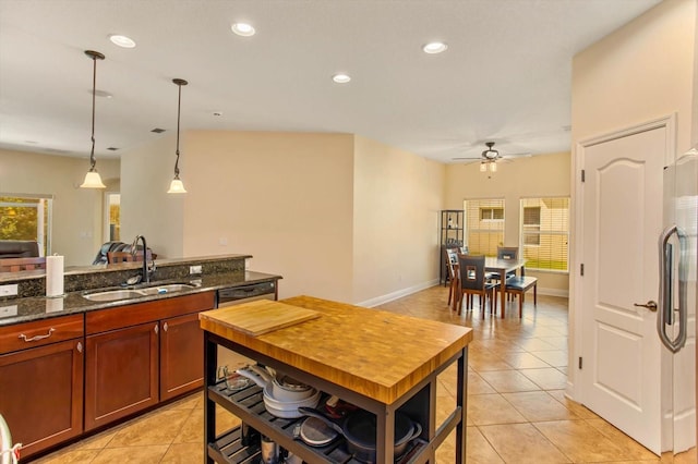 kitchen with recessed lighting, stainless steel fridge, a sink, and light tile patterned floors