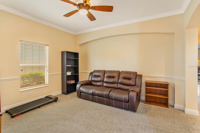 carpeted living room with ceiling fan, ornamental molding, and baseboards