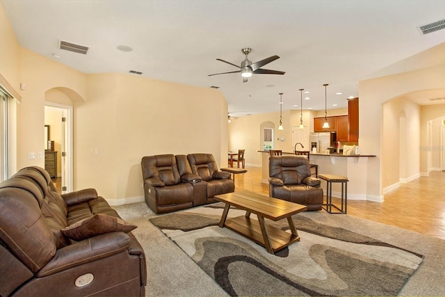 living room with visible vents and arched walkways