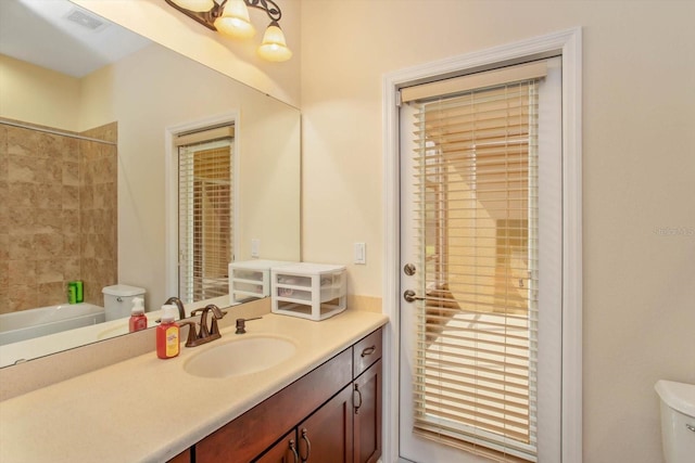 full bath featuring visible vents, toilet, vanity, a tub, and walk in shower