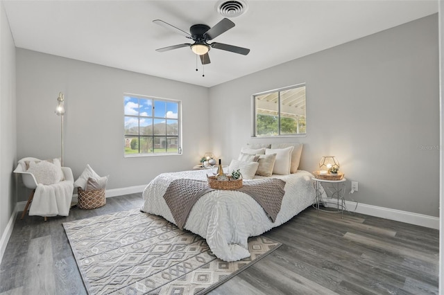 bedroom featuring visible vents, multiple windows, and baseboards