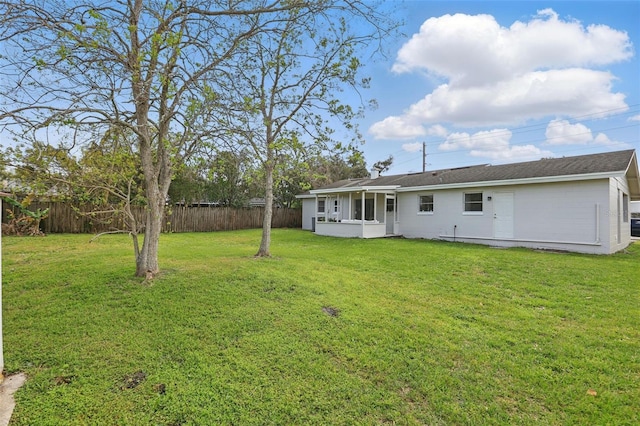 exterior space with a sunroom and fence