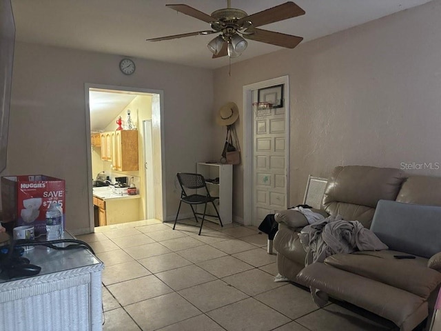 living area featuring a ceiling fan and light tile patterned flooring