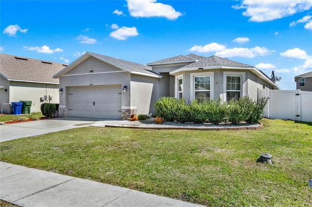 view of front of property with driveway, a garage, a gate, a front lawn, and stucco siding