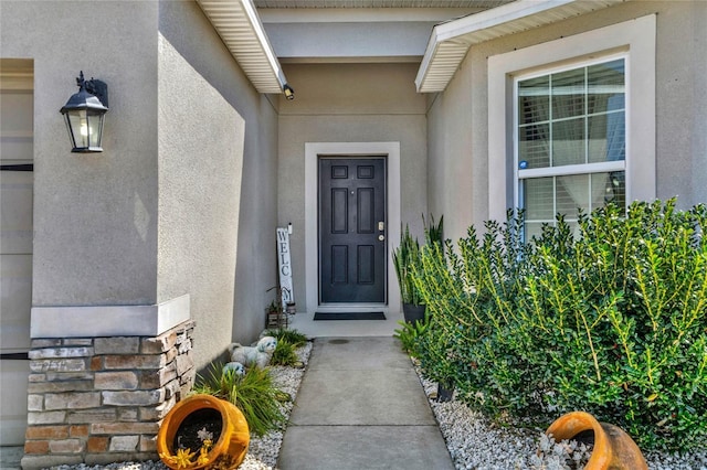 entrance to property featuring stucco siding