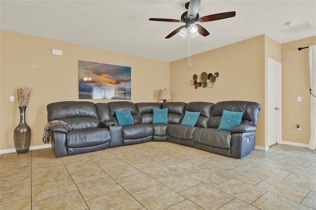 living area featuring a textured ceiling, light tile patterned floors, and visible vents