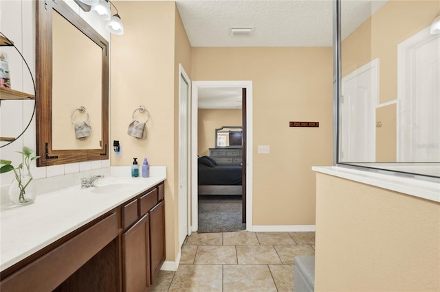 ensuite bathroom with visible vents, ensuite bath, tile patterned flooring, a textured ceiling, and vanity