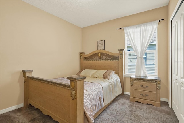 carpeted bedroom featuring multiple windows, a closet, and baseboards