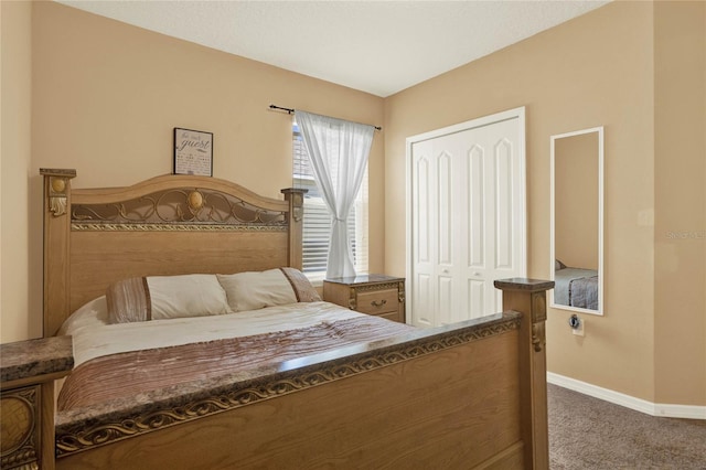 bedroom featuring a closet, carpet flooring, and baseboards