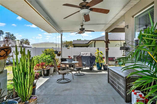 view of patio / terrace with ceiling fan, area for grilling, and a fenced backyard