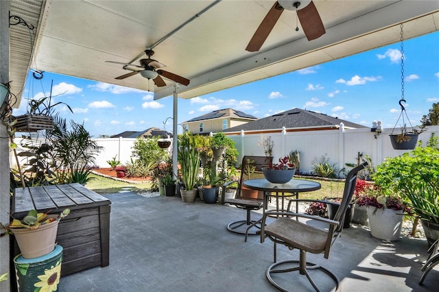 view of patio / terrace with a fenced backyard, a ceiling fan, and outdoor dining space